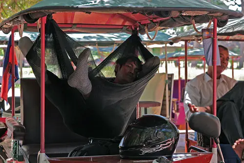 cambodian tuk-tuk driver relaxes