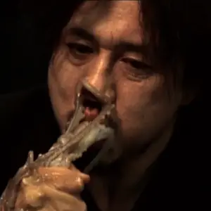 old boy eating a live octopus