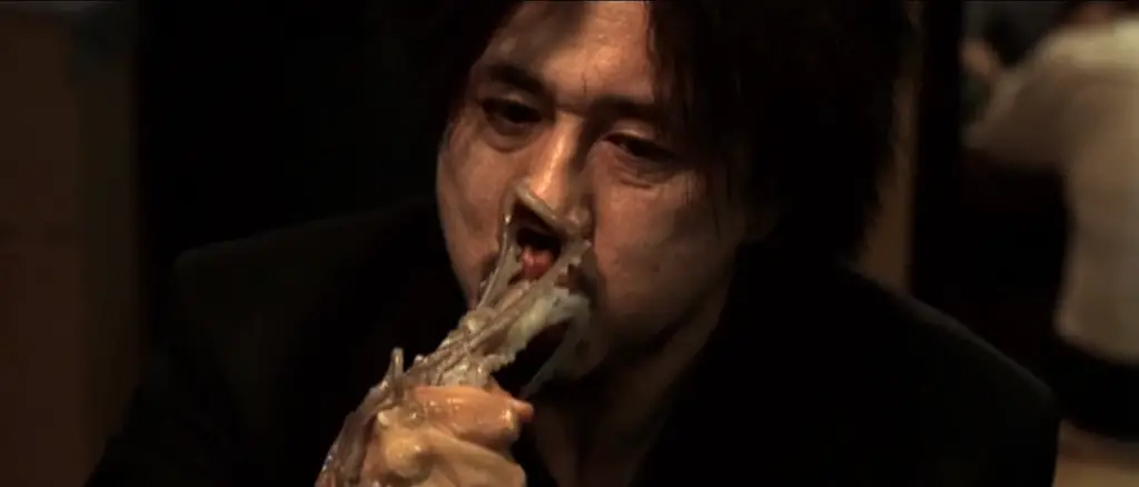 old boy eating a live octopus